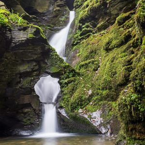 beautiful fairy waterfall, green moss covered cliffs, st nectans glen, corrnwall